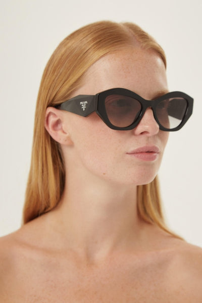 Prada oval black sunglasses featuring iconic logo - Lux Studios