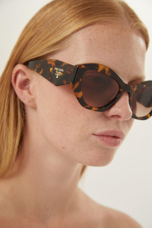 Prada oval sunglasses featuring iconic logo - Lux Studios